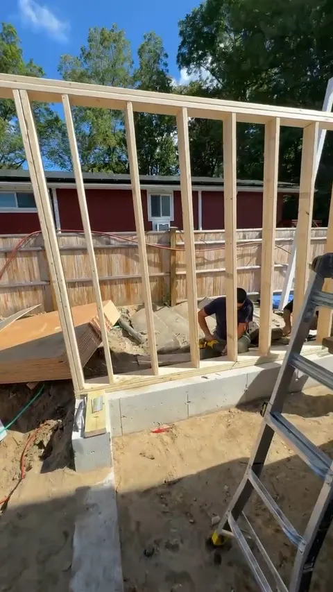 New wall framing going up on a concrete footing.