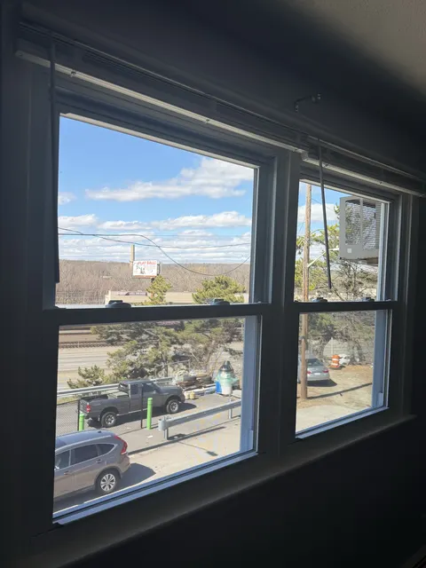 New white double-hung windows in the same house after replacement.